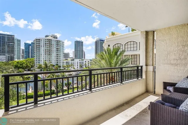 a view of a balcony with dining table and chairs plants with wooden floor