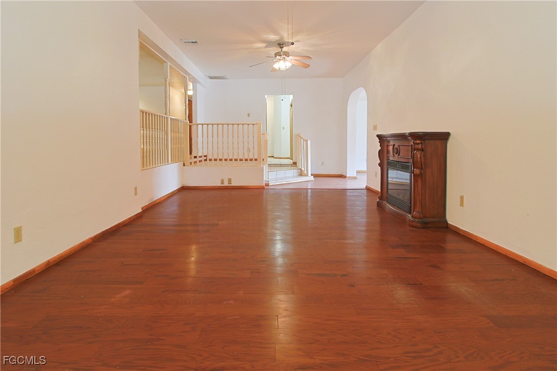 6620 Golden Road North Fort Myers, FL 33917 - Photo 12 of 26 an empty room with wooden floor and windows