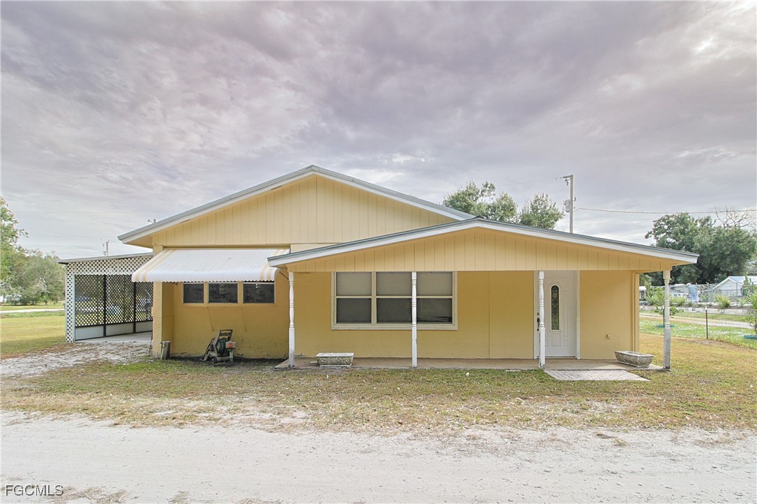 6620 Golden Road North Fort Myers, FL 33917 - Photo 2 of 26 front view of a house with a yard