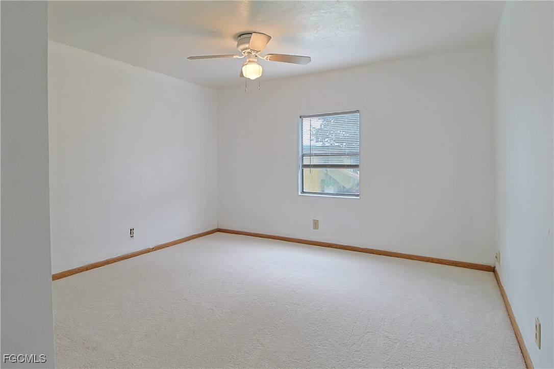 6620 Golden Road North Fort Myers, FL 33917 - Photo 21 of 26 an empty room with a window and a fan