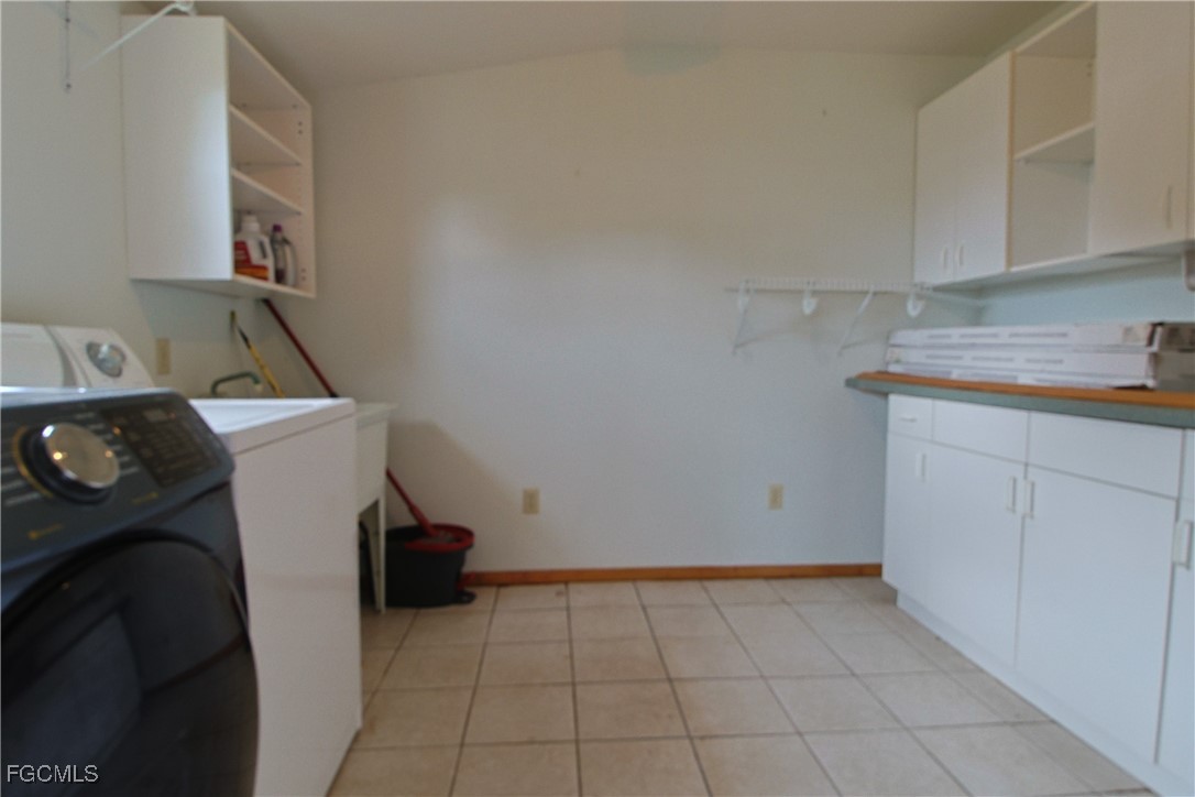 6620 Golden Road North Fort Myers, FL 33917 - Photo 26 of 26 a view of storage and utility room with washer and dryer