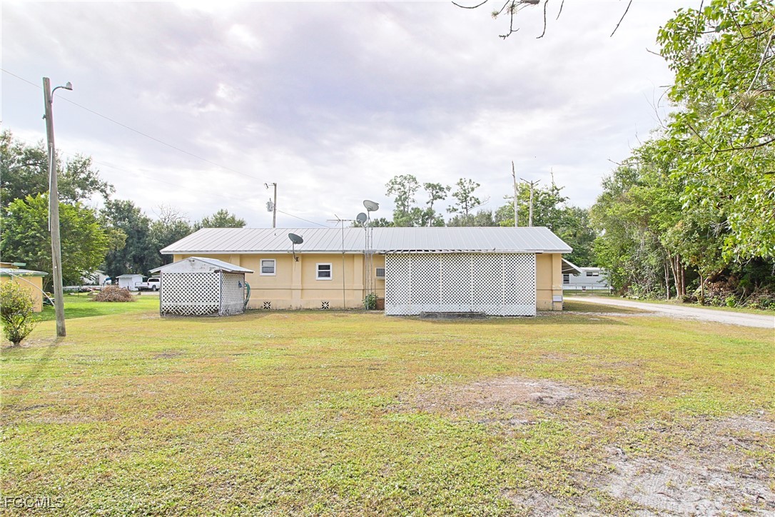 6620 Golden Road North Fort Myers, FL 33917 - Photo 4 of 26 a front view of a house with a garden and lake view