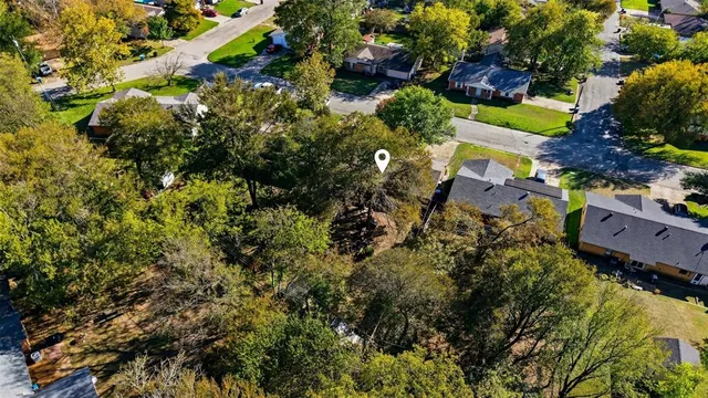 an aerial view of residential house with yard and outdoor seating