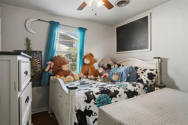 a bed room with bed and a flat tv screen