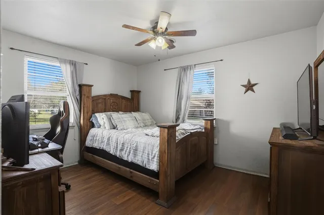 a bedroom with a bed and a flat screen tv
