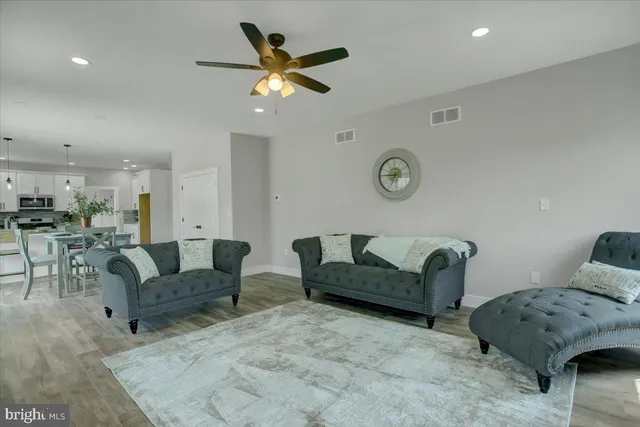 a living room with furniture and a clock