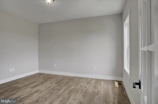 a view of an empty room and wooden floor