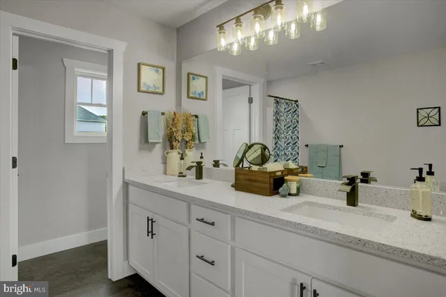 a bathroom with double vanity sinks a vanity and a mirror