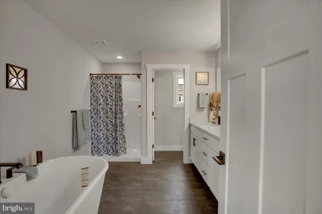 a bathroom with a bathtub and a sink