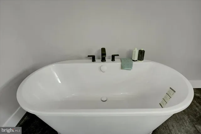 a white bath tub sitting next to a white sink