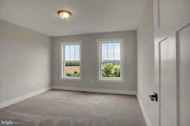 a view of an empty room and closet area