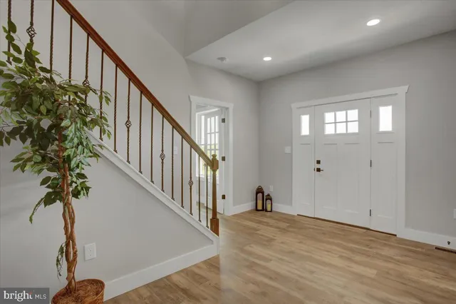 a view of an entryway with wooden floor and stairs