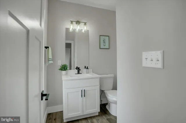 a bathroom with a sink a toilet and mirror