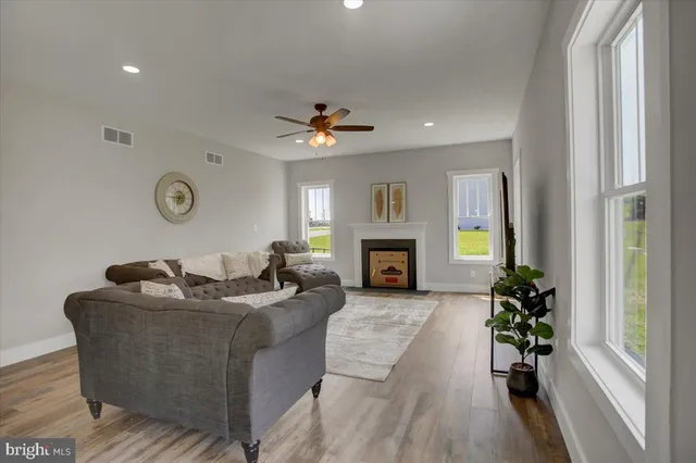 a living room with furniture a fireplace and a window