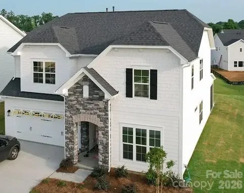 a front view of a house with plants
