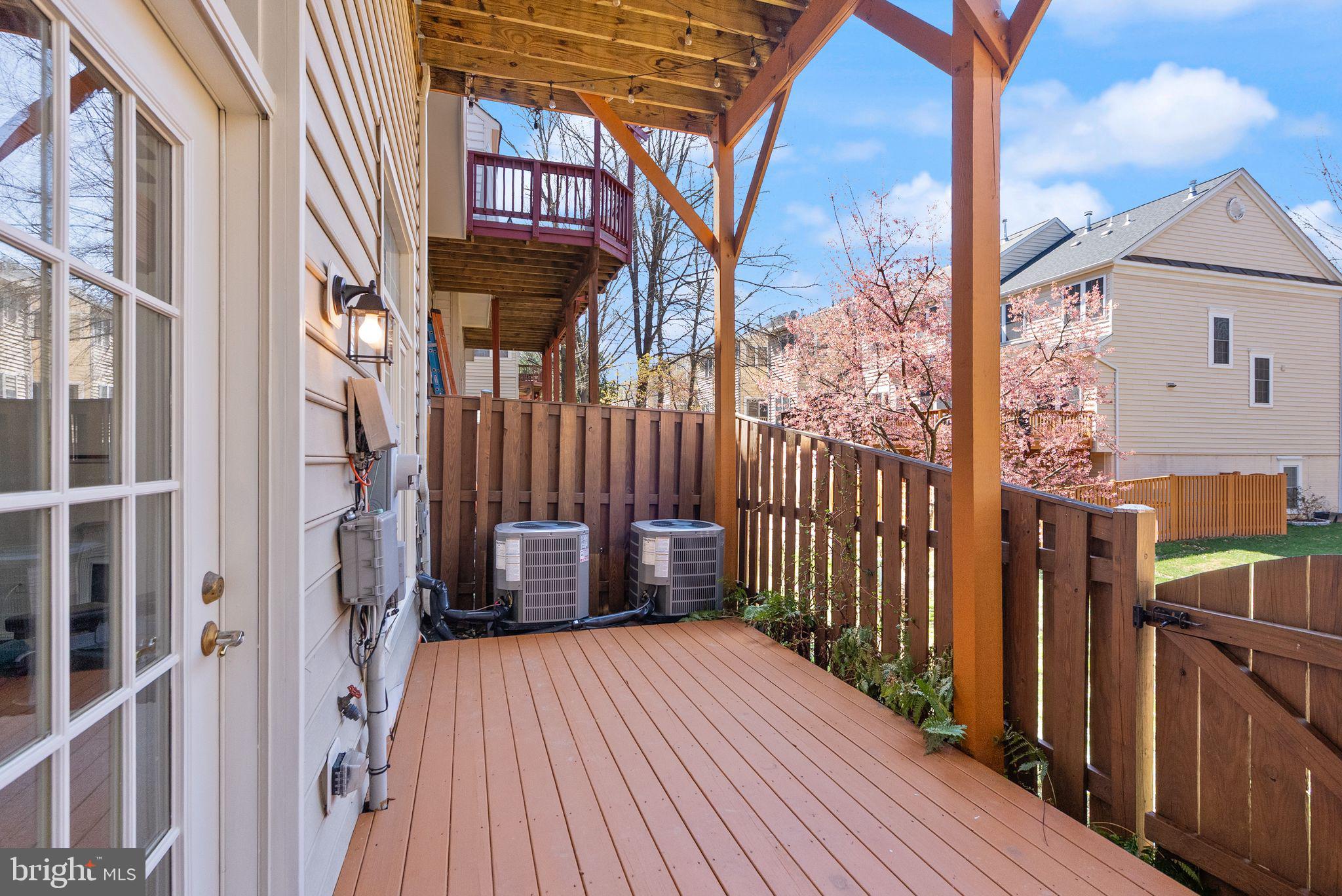 4132 Timber Log Way Fairfax, VA 22030 - Photo 58 of 69 a view of a brick house with wooden floor and wooden fence