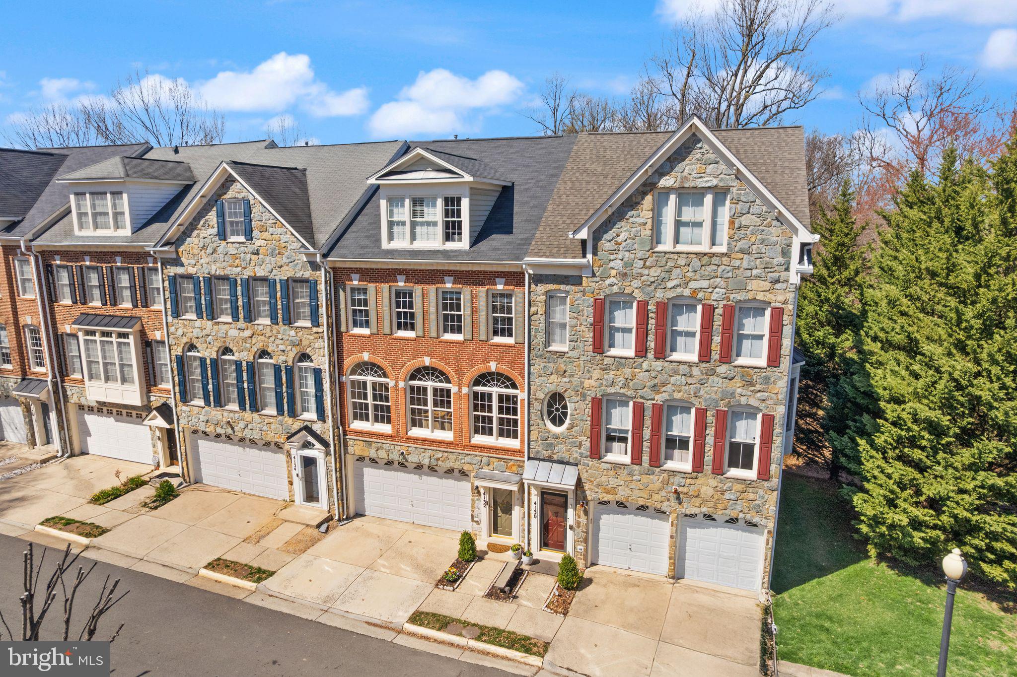 4132 Timber Log Way Fairfax, VA 22030 - Photo 8 of 69 a front view of a residential apartment building with a yard