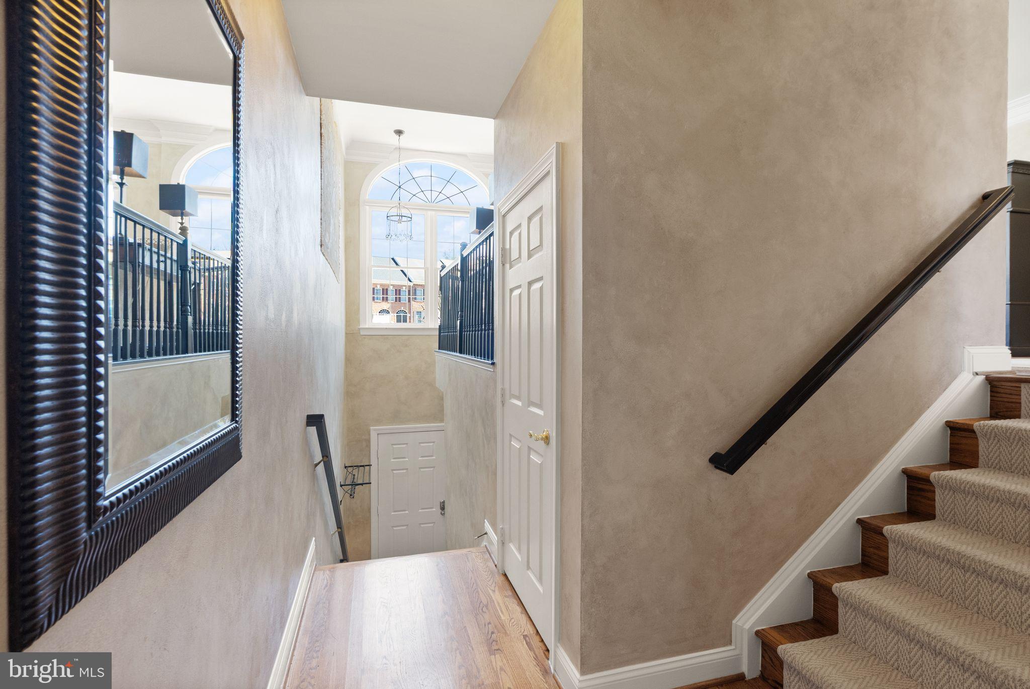 4132 Timber Log Way Fairfax, VA 22030 - Photo 10 of 69 a view of a hallway with wooden floor and staircase