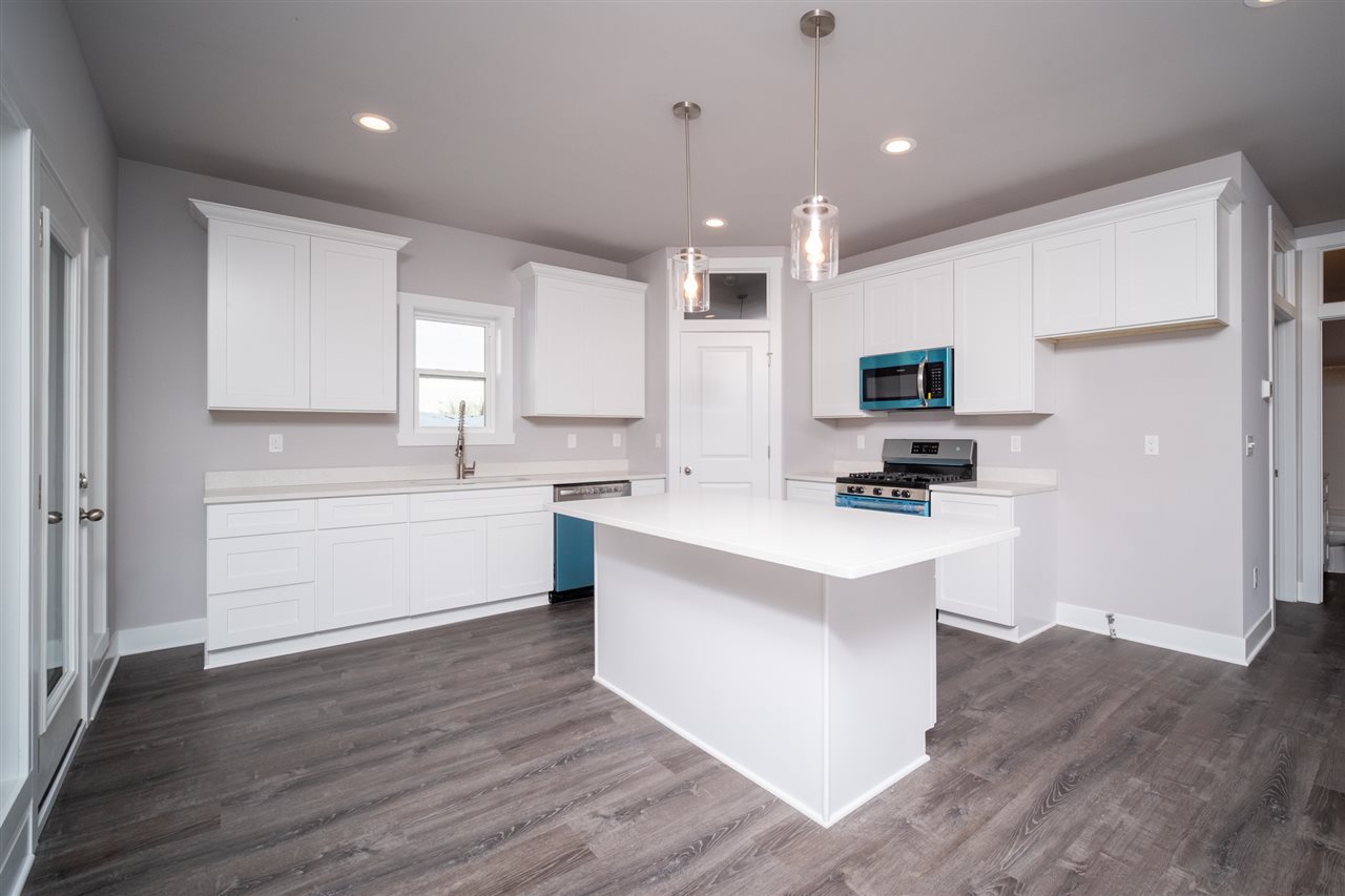2435 Court Ridge Road Belvidere, IL 61008 - Photo 2 of 20 a kitchen with kitchen island granite countertop a sink appliances cabinets and a counter top space