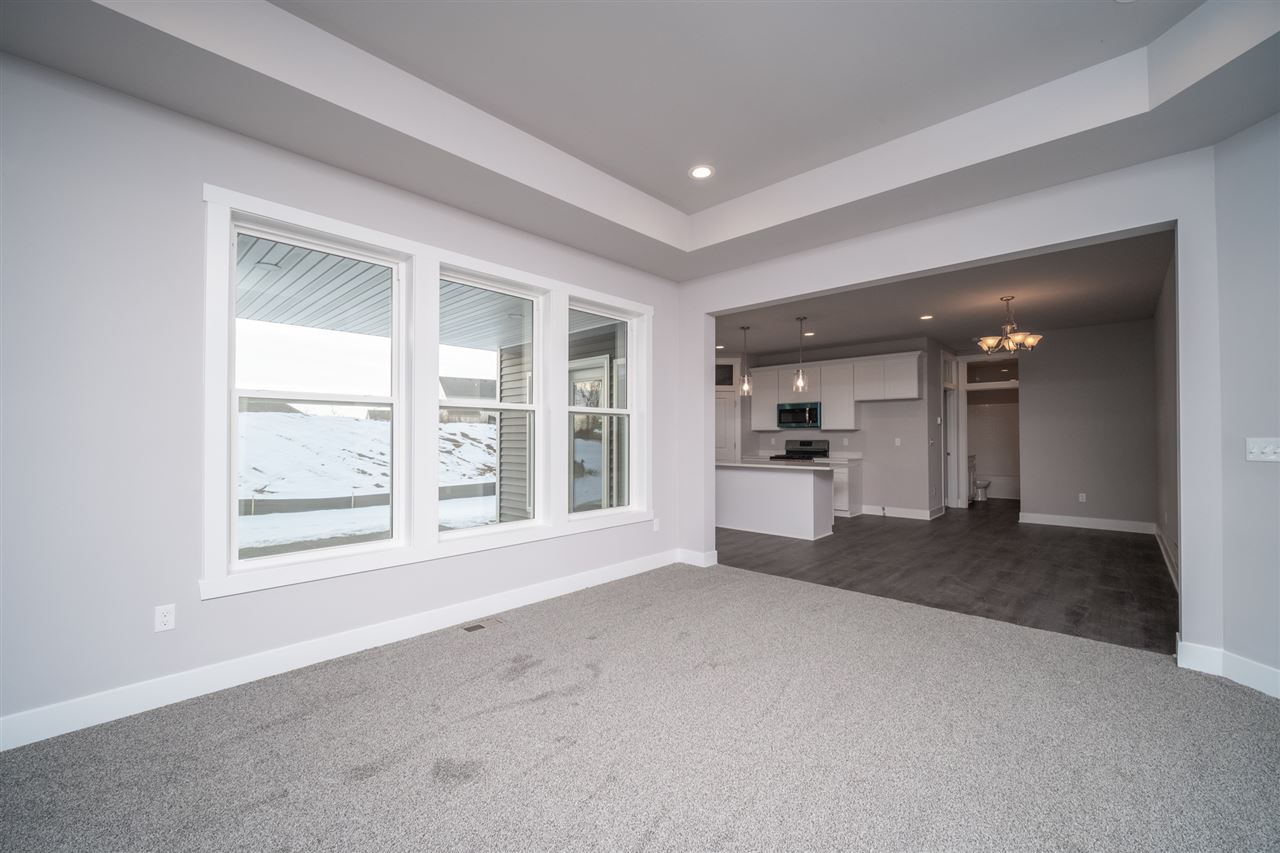 2435 Court Ridge Road Belvidere, IL 61008 - Photo 8 of 20 an empty room with a kitchen and large windows