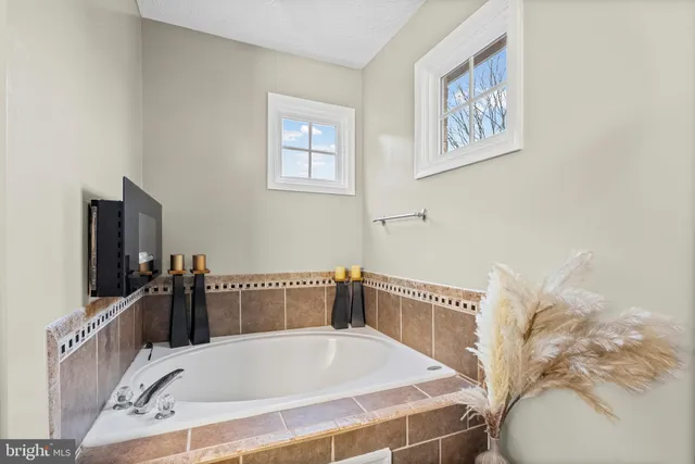 a bath tub sitting next to a blue wall