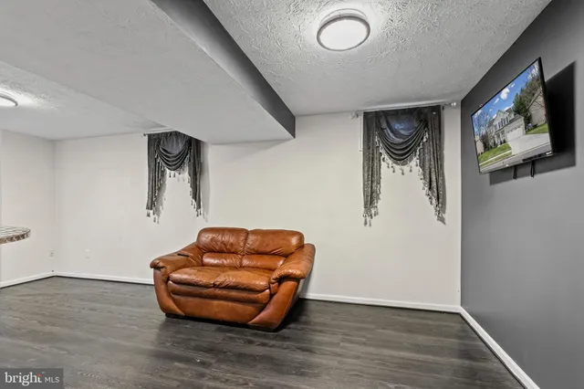 a blue room with wooden floor and furniture