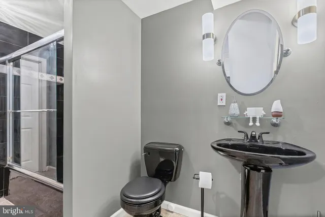 a bathroom with a toilet sink and mirror