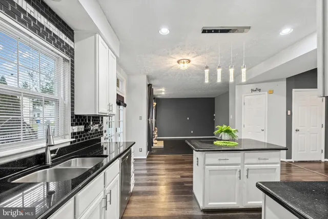 a kitchen with stainless steel appliances a sink stove and cabinets
