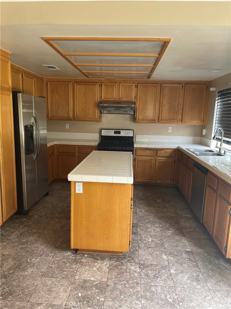 19284 Krameria Avenue Riverside, CA 92508 - Photo 24 of 26 a kitchen with stainless steel appliances granite countertop a sink stove and refrigerator