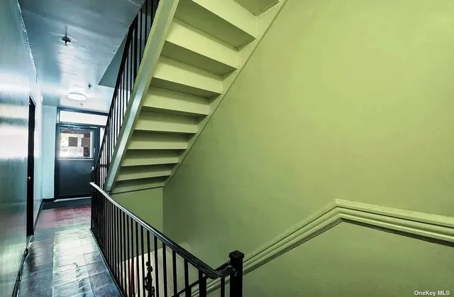 a bedroom with a bed and a flat tv screen on the dresser