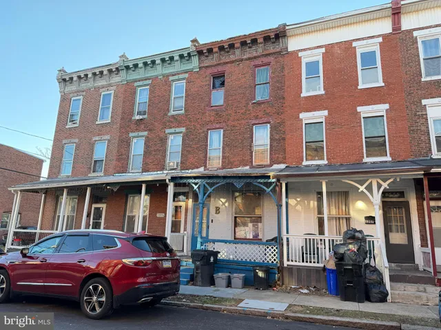 a front view of a building with parking space