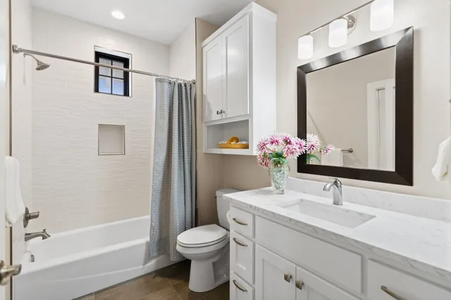 a spacious bedroom with a large bed and a large window