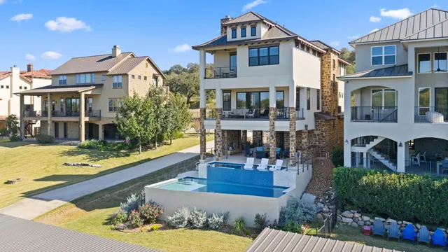a front view of a house with swimming pool having outdoor seating