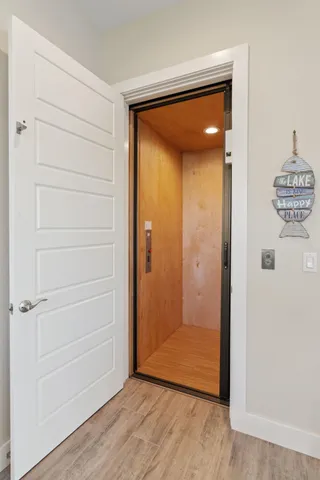 an empty room with wooden floor and a door