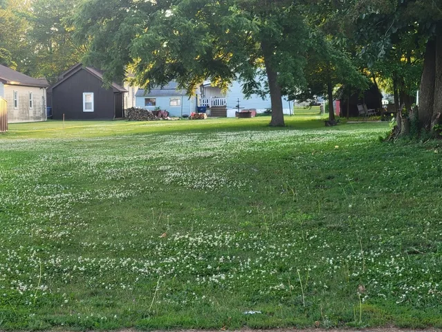 a large house with a big yard and large trees