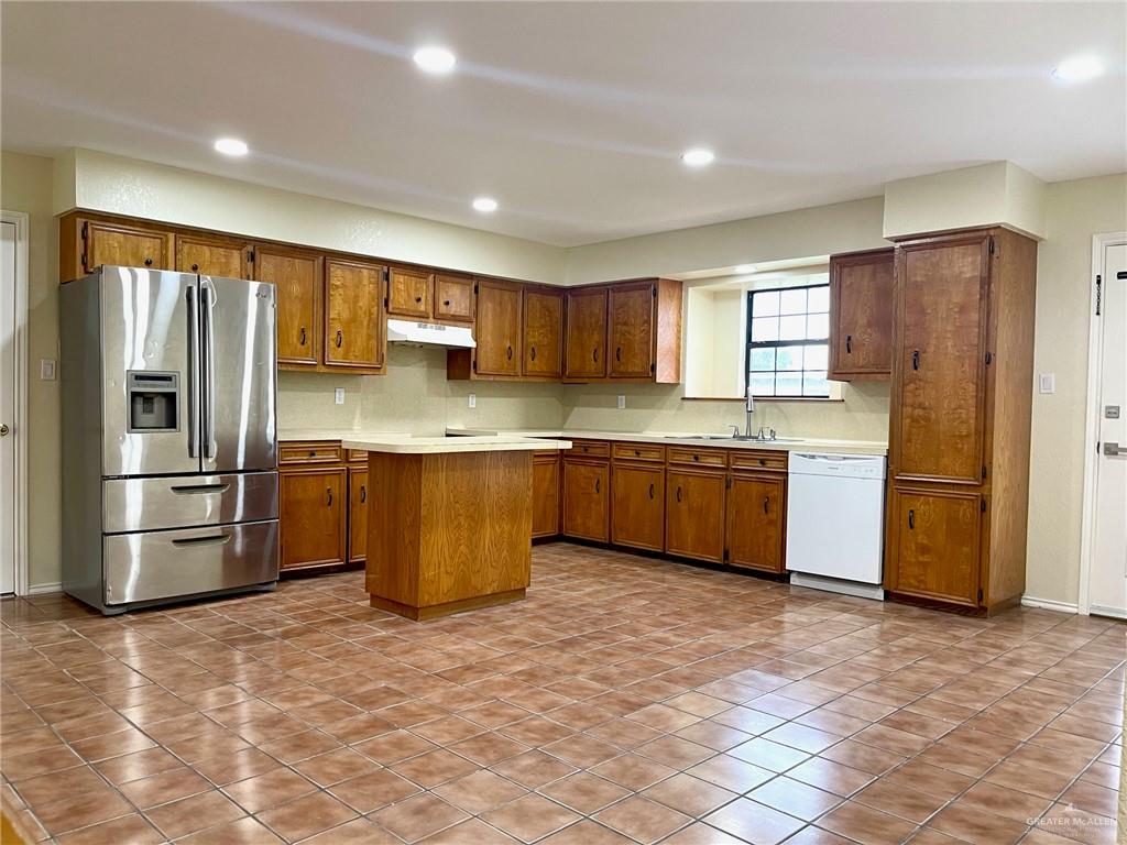 5307 Fm 493 Road Donna, TX 78537 - Photo 11 of 27 Kitchen featuring sink, tasteful backsplash, tile floors, dishwasher, and stainless steel fridge with ice dispenser