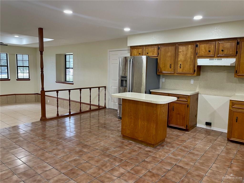 5307 Fm 493 Road Donna, TX 78537 - Photo 13 of 27 Kitchen featuring a kitchen island, light tile floors, and stainless steel fridge