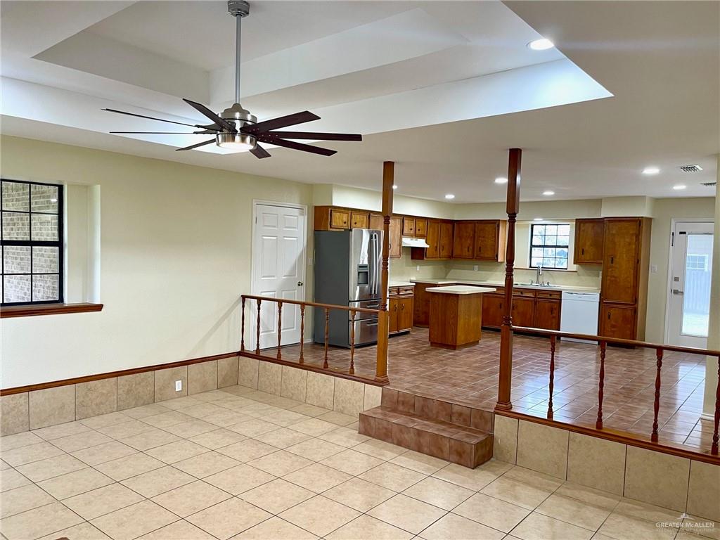 5307 Fm 493 Road Donna, TX 78537 - Photo 8 of 27 Kitchen with light tile flooring, stainless steel fridge, a kitchen island, and ceiling fan