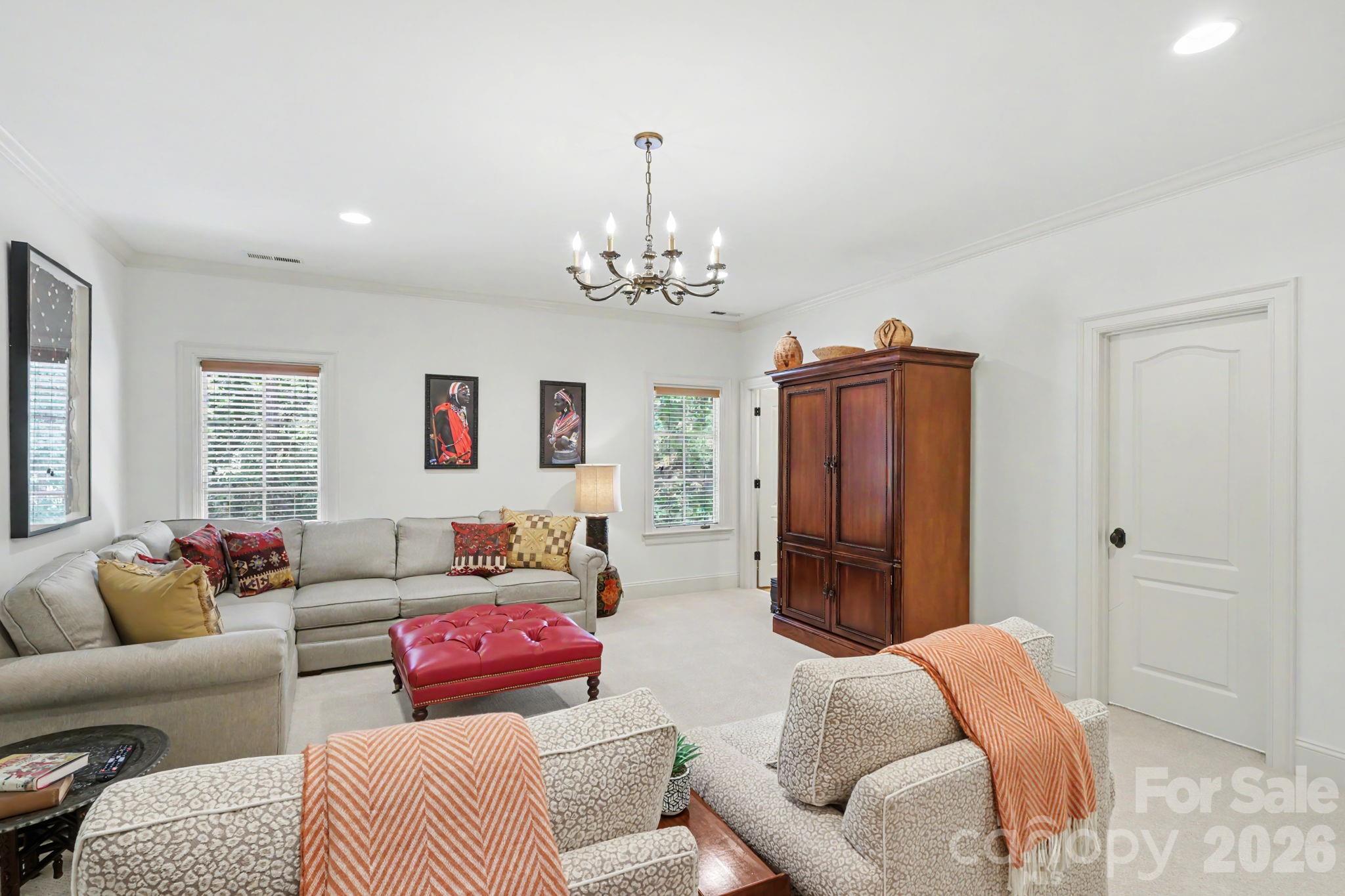 508 Hideaway Ridge Court Matthews, NC 28105 - Photo 29 of 47 a living room with furniture and a chandelier