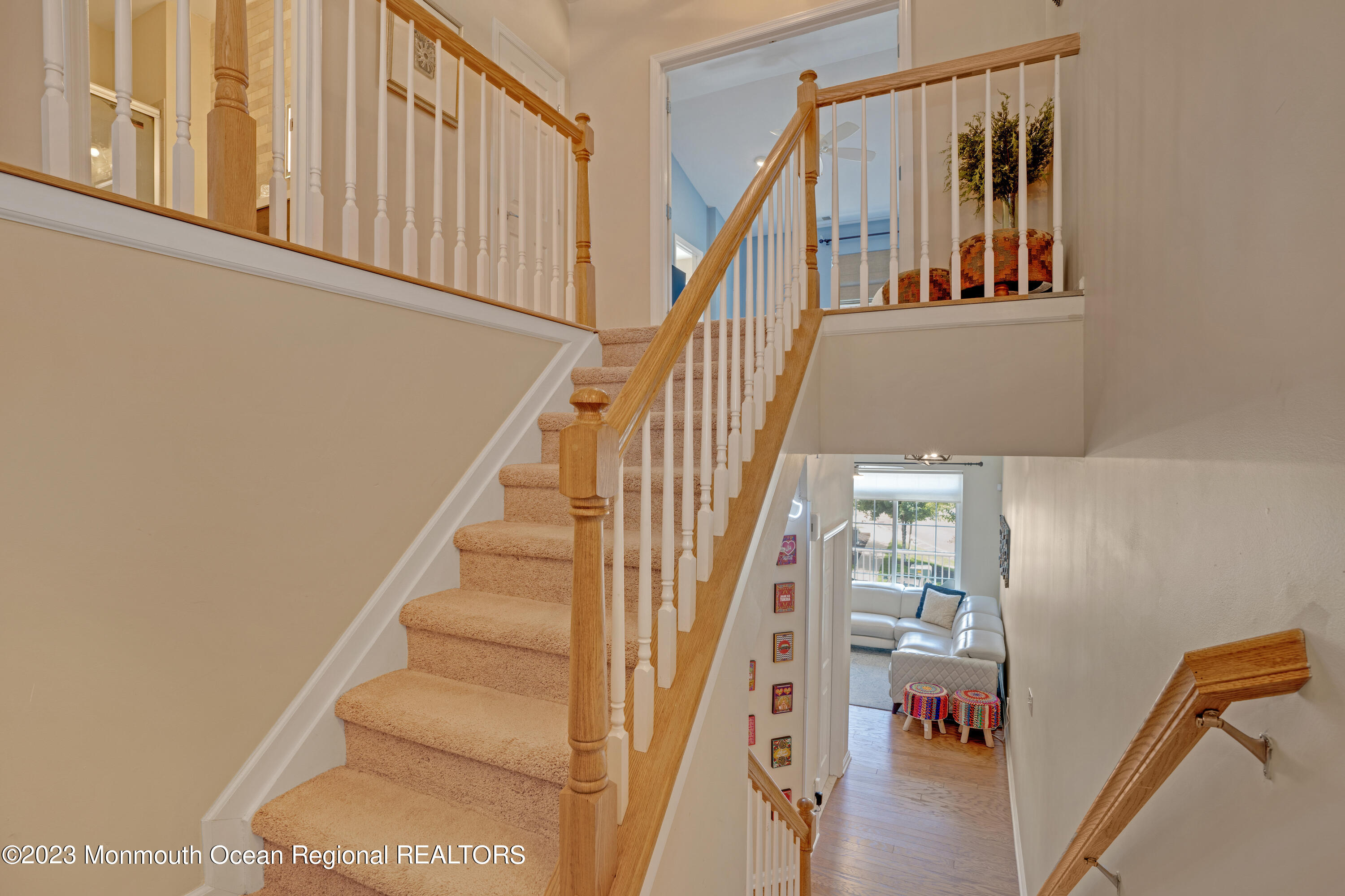 7 Iris Lane, Unit 504 Garfield, NJ 07026 - Photo 13 of 31 a view of staircase with lots of frames on wall and a window