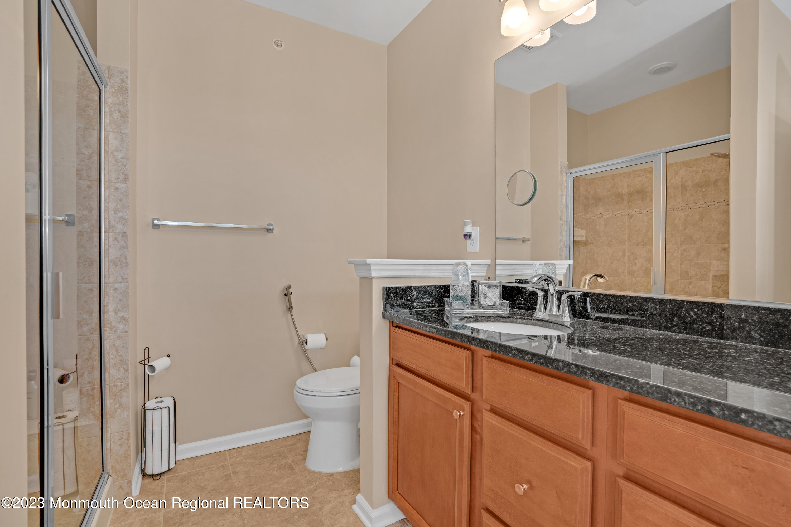 7 Iris Lane, Unit 504 Garfield, NJ 07026 - Photo 22 of 31 a spacious bathroom with a granite countertop sink a toilet and a mirror