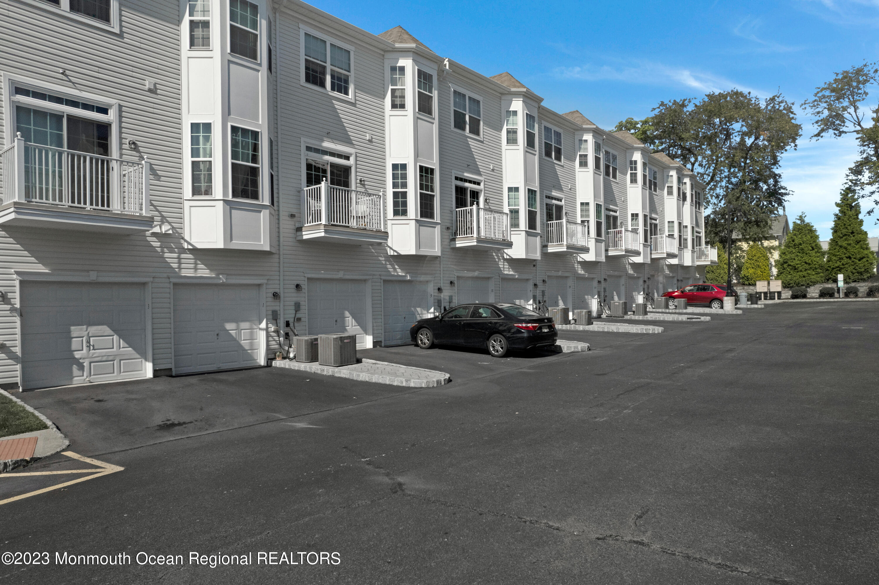 7 Iris Lane, Unit 504 Garfield, NJ 07026 - Photo 29 of 31 a building with car parked in front of it