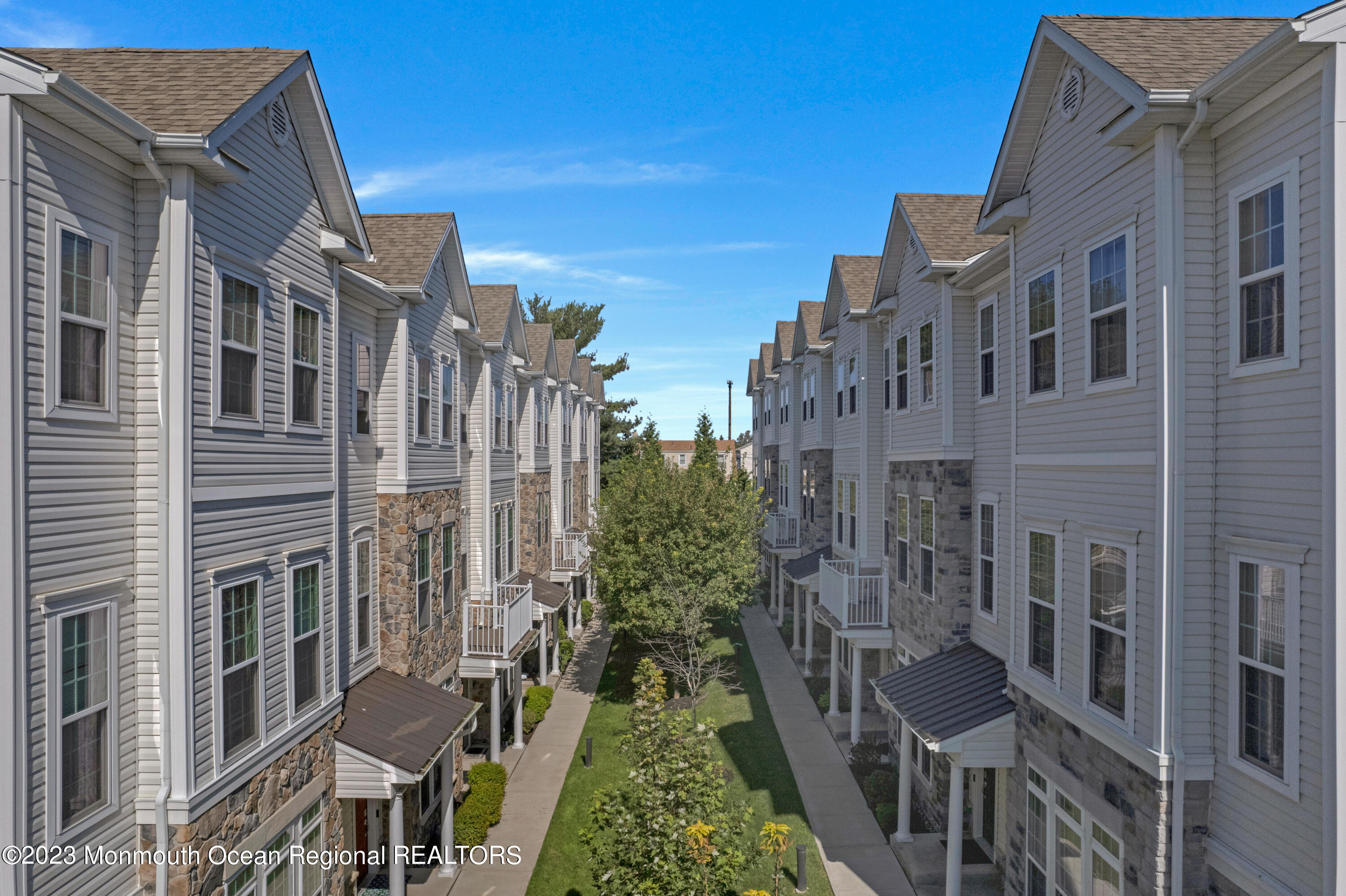 7 Iris Lane, Unit 504 Garfield, NJ 07026 - Photo 3 of 31 a view of a brick building next to a yard
