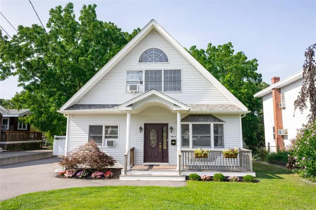 a front view of a house with a garden and porch