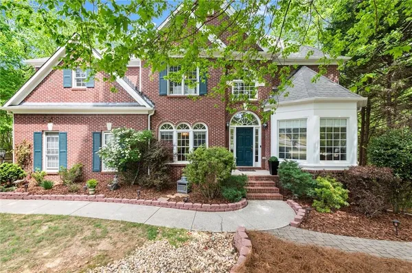 a front view of a house with garden