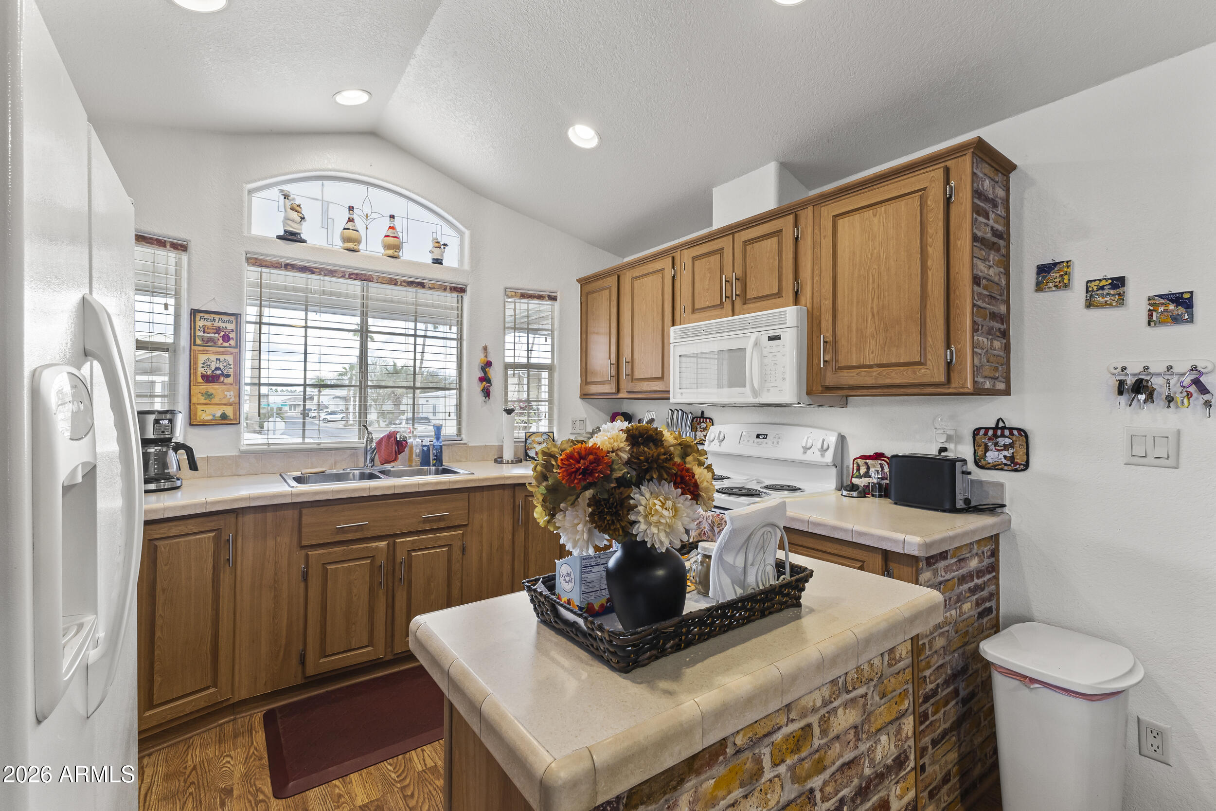 17200 West Bell Road, Unit 548 Surprise, AZ 85374 - Photo 5 of 19 a kitchen with a appliances cabinets and a table