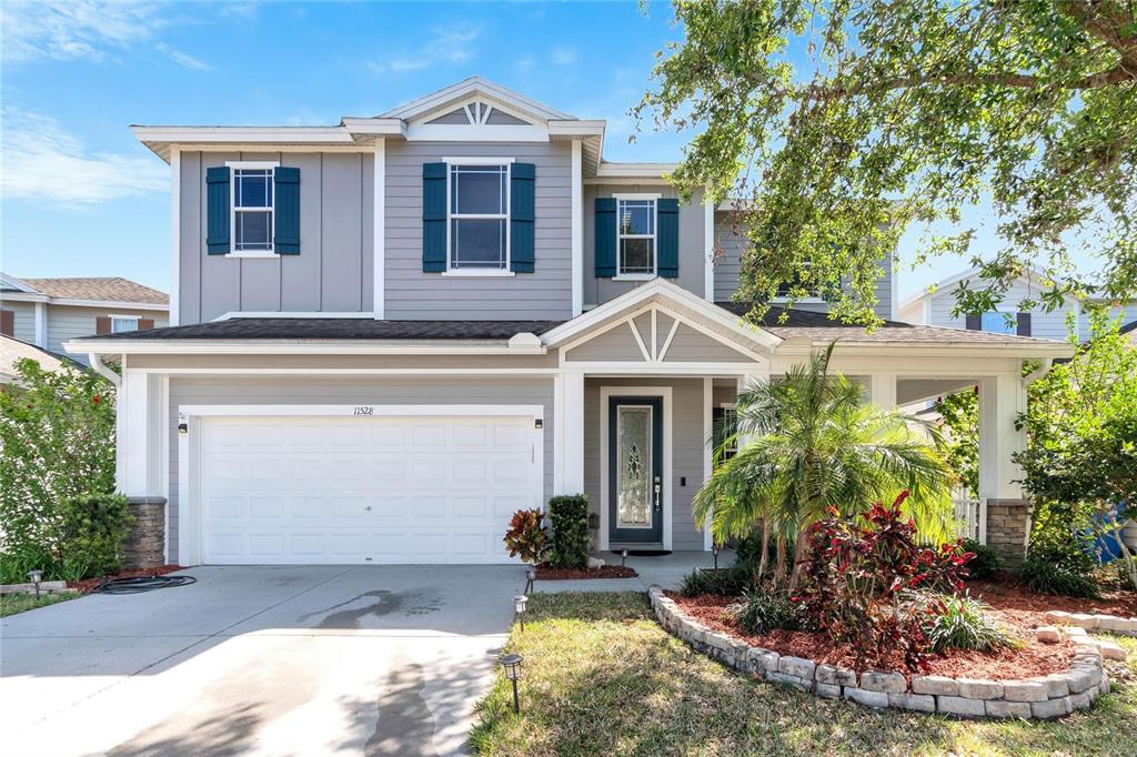 11528 Balintore Drive Riverview, FL 33579 - Photo 1 of 1 a front view of a house with a yard and potted plants