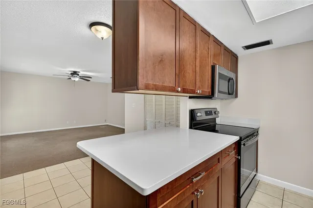 a kitchen with stainless steel appliances a sink stove and cabinets