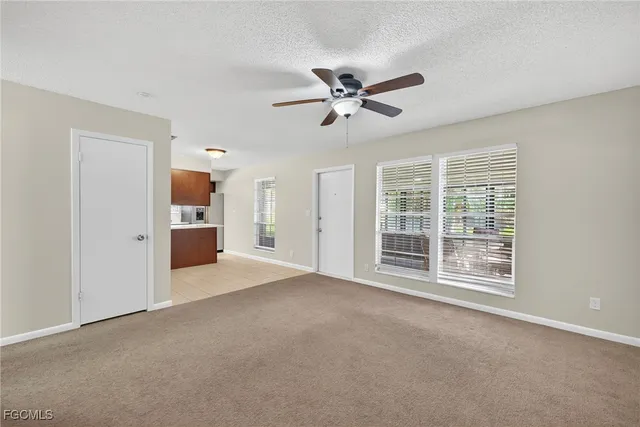 a view of kitchen with sink microwave and refrigerator