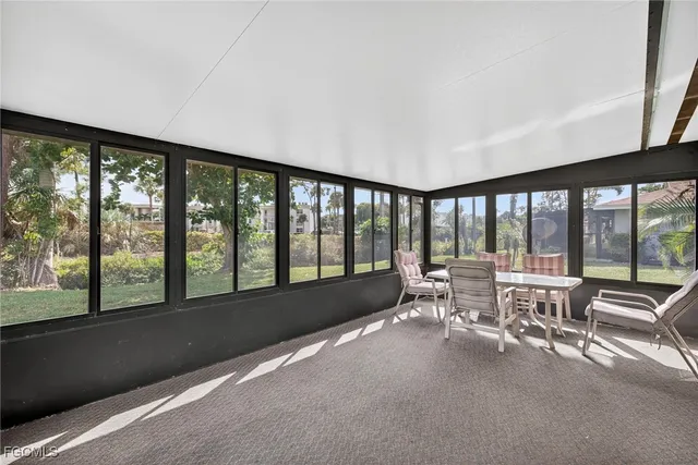 a lobby with furniture and large windows